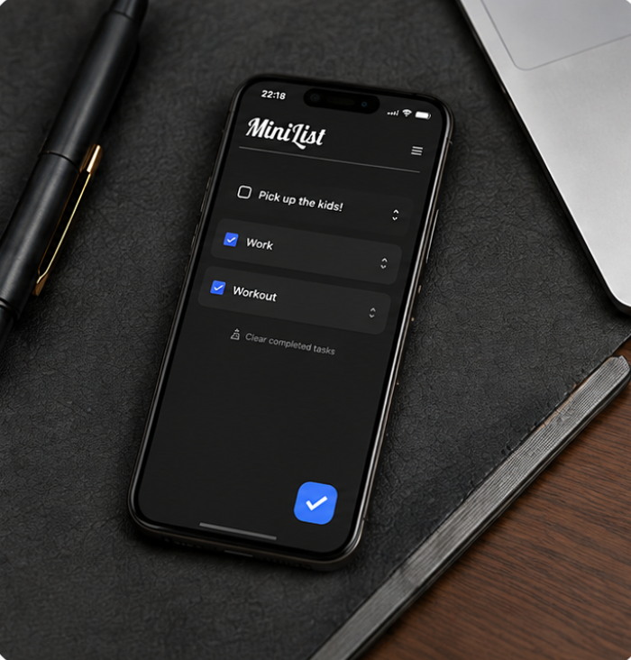 MiniList dark mode on an iPhone placed on a desk